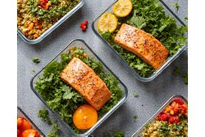 Overhead view of a colorful, healthy meal prep spread with fresh ingredients.