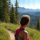 Person hiking on a trail near Boulder's Flatirons, taking a mindful breath, connecting with nature.